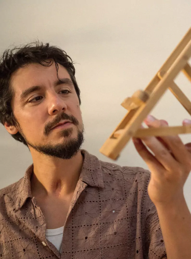 Levelty's founder holding the unfolded bamboo stand